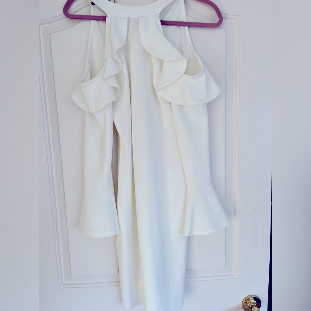White long sleeve dress with ruffle open shoulder sleeve.